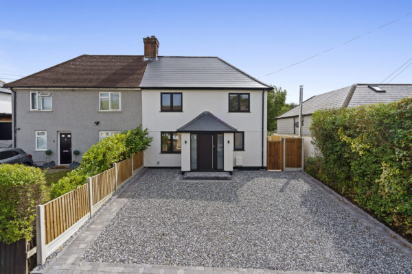 Real estate photo of family home with spacious stone driveway