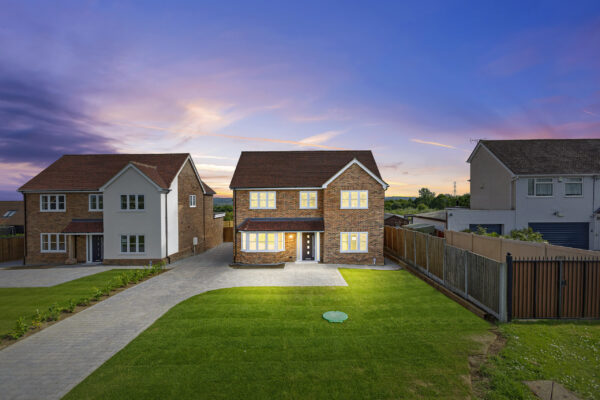 Exterior twilight shot with warm lighting for property listing