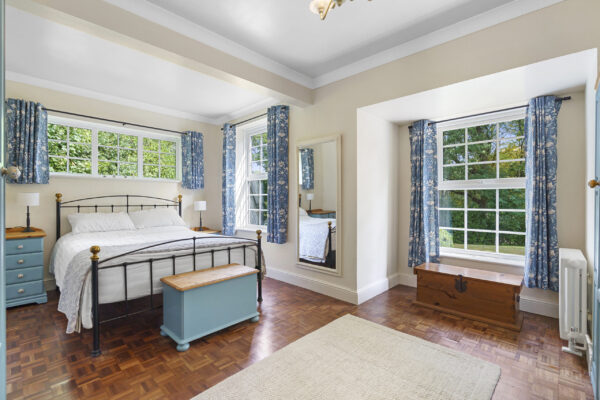 Master bedroom with neutral decor and natural light