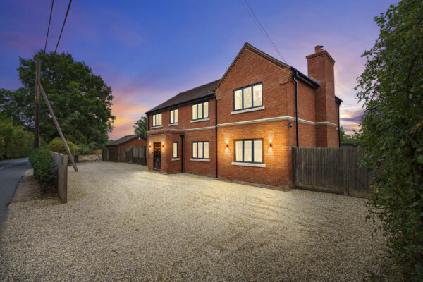 Dusk photo of home exterior with glowing windows